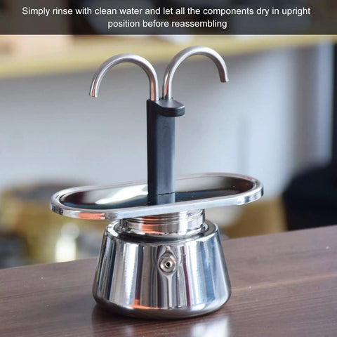 Stovetop Espresso Maker Real Deal Silver Stainless Steel Two Cup Italian Brew Pot With Dual Spout Handle on wooden surface.