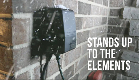 Heavy Duty Outdoor Plug-In Timer Built Tough For Pool Pumps And Yard Lights, installed on a brick wall, protected from snow.