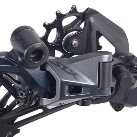 Close-up of 12 Speed Rear Derailleur Rd M7120 SGS for Mountain Bikes with Direct Mount Cushioned Pads 13T Pulley Wheel
