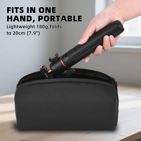 21 Inch Grab And Go Portable Selfie Stick Tripod With Quick Release Magnetic Lock fits in small black bag on table.
