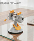 Ultimate Mini Bench Vise With Suction Base, Top Notch Aluminum Alloy Clamp Perfect For Jewelry And Electronics Repair, Compact Workholding Tool on a glass table.