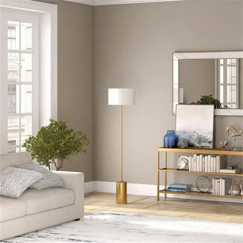 64 Inch Tall Floor Lamp With Brass Finish And White Linen Drum Shade Dope Modern Home Lighting For Living Room Or Bedroom Compatible With Incandescent LED CFL Bulbs next to a sofa and bookshelf in a living room setting.