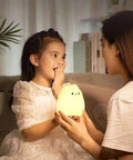 Child receiving LED Cat Night Light For Kids Battery Powered Silicone Cat Nursery Night Light With 2 Soft Glow Modes