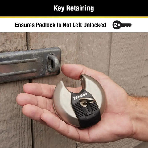 Hand holding Beefed Up Stainless Steel Discus Lock with Tough Cut Boron Carbide Shackle near a latch, ideal for security.