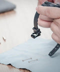 Hands holding a watch band above Two Pack Screw In Metal Watch Band Pins 0.98 X 0.15 Inch Replacement Link Rods on cloth.
