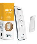 Pure White RTS Remote For One Motorized Shade Or Group, Single Channel Control, with wall mount holder on display.