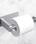 Self Adhesive Toilet Paper Holder No Drill Wall Mount Stainless Steel Brushed Finish Stick On Bathroom Roll Holder For Kitchen Washroom Rustproof Easy Clean Quick Install No Tools Required displayed on marble wall with toilet paper.