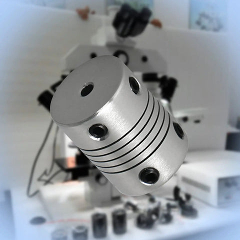Close-up of Flexible Beam Coupling 3mm To 5mm Shaft Size 25mm Length 1 Inch With 19mm Outer Diameter next to CNC machine