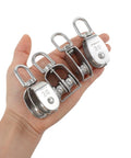 Hand holding 4 Pack M20 Lifting Single Pulley Block With 304 Stainless Steel Construction showcasing size and durability.