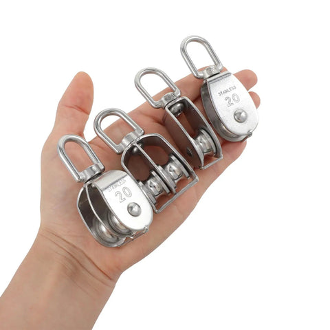 Hand holding 4 Pack M20 Lifting Single Pulley Block With 304 Stainless Steel Construction showcasing size and durability.
