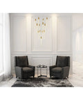 Modern 13 Bulb Pendant Ceiling Light Featuring Satin Gold Hardware And Clear Crystals above two grey armchairs in elegant room.