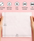 Hands holding ultra soft disposable face towels for travel essentials on the go extra large wipes for cleanse and makeup removal highly absorbent and lint free vegan facial tissues 60 count