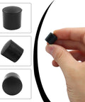 Pack Of 24 Black Door Stop Rubber Tips Replacement End Caps Universal Bumper For Wall And Floor Protection shown close-up held by hand