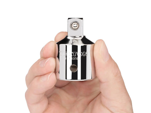 Hand holding a 3/4 Inch Drive To 1/2 Inch Drive Reducer Adapter with detent grooves and locking hole for secure fit.