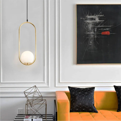 Modern One Light Globe Pendant With White Milk Glass Shade In Brushed Brass Finish for stylish living room décor.
