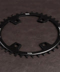 42T 110BCD 4 Bolt CNC Aluminum Narrow Wide Chainring For Road Bike Single Chainring Sprocket on dark surface