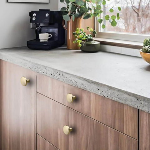 Gold Cabinet Knobs Set installed on wooden dresser under concrete countertop, Round Brushed Brass Zinc Alloy Hardware, 25 Pack by Homdiy