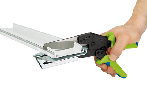 Hand using Wiring Duct Cutter for Plastic Panels Baseboards and Cable Ducts Up to Four and Half Inch Depth Handheld Tool on material