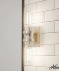 Lenlock 2 Light Brushed Nickel Vanity Light with Seeded Glass Shade and Steel Construction on tiled wall