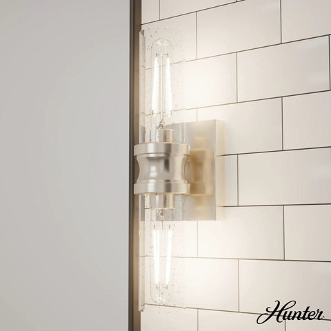 Lenlock 2 Light Brushed Nickel Vanity Light with Seeded Glass Shade and Steel Construction on tiled wall