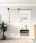 Heavy Duty 6 Foot Sliding Barn Door Hardware Kit For Single Door Featuring Hard Core Black Aluminum Track and installed on white door.