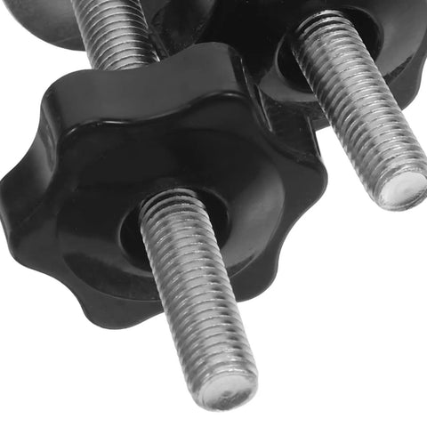 Close-up of four star shaped T track knobs with stainless bolts and washers for woodworking fixtures and jigs.