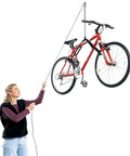 Woman using Overhead Garage Hoist System For Bikes And Ladders Single Point Lift 45lb Capacity Self Leveling With Anti Drop Safety Easy One Person Operation Space Saving Ceiling Mount 10ft 12ft Or 16ft Heights to lift a bike