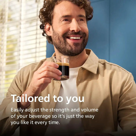 Man enjoying a cup of espresso from the Fully Automatic Espresso Coffee Maker With Integrated Grinder And LatteGo Milk System.