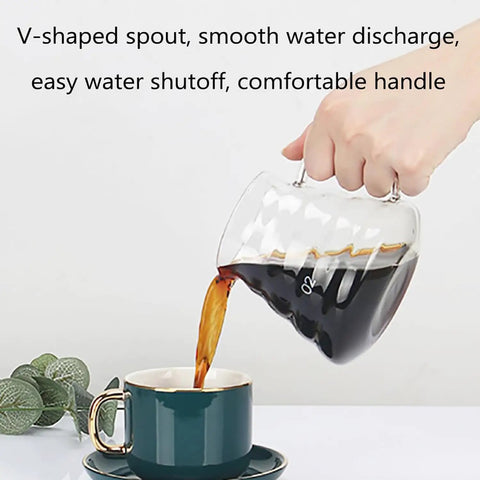 Top Shelf Cold Brew Coffee Maker With Clear Glass Carafe pouring coffee into a teal cup, showcasing its V-shaped spout.