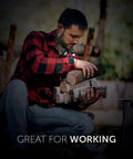 Man wearing Real Tree 300 Lumen Hands Free Neck Light With Red And White LEDs, carrying firewood outdoors.