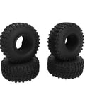 Set of four black off-road tires stacked in pairs, featuring deep treads for rugged terrain, suitable for RC cars and similar vehicles.