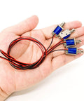 Hand holding Tiny 12V Micro Push Pull Solenoid Electromagnet, Ultra Compact Mini Linear Actuator, 4-pack, with wires attached