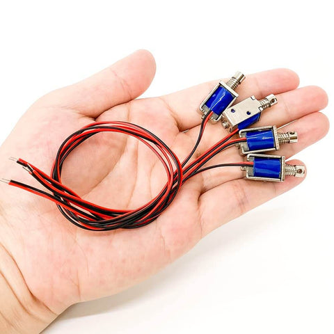 Hand holding Tiny 12V Micro Push Pull Solenoid Electromagnet, Ultra Compact Mini Linear Actuator, 4-pack, with wires attached