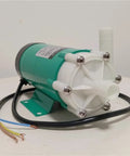 Tough As Nails Miniature Magnetic Circulation Pump With Corrosion Resistant Construction To Handle Acid And Alkali Fluids Efficiently In Industrial Operations, showing green motor with white fittings.