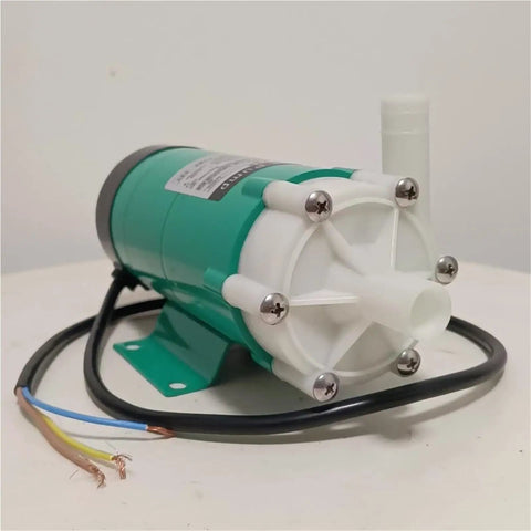 Tough As Nails Miniature Magnetic Circulation Pump With Corrosion Resistant Construction To Handle Acid And Alkali Fluids Efficiently In Industrial Operations, showing green motor with white fittings.