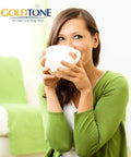 Woman in green holding a white cup, representing Reusable Cup No 2 Cone Coffee Filter Size 4 Fits Most Cuisinart Krups And Other Cone Coffee Makers Durable Permanent Plastic Filter For Everyday Home Kitchen And Office Brews Your Daily Joe