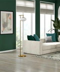 Go To 68 Inch Tall Arc Floor Lamp With Glass Shade In Brushed Brass And Milk White in a modern living room setting.