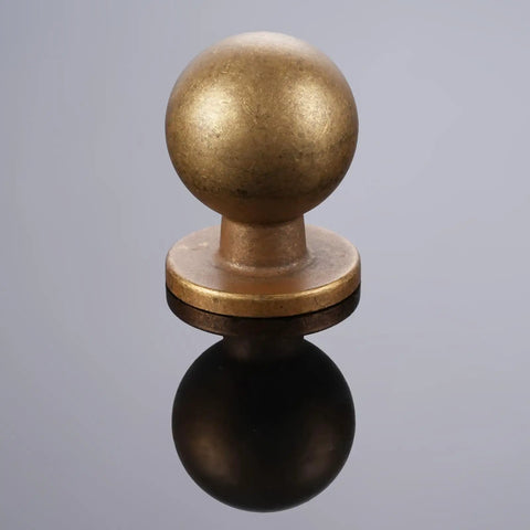 Top Shelf Antique Brass Kitchen Cabinet Knobs And Drawer Pulls Two Pack Sturdy Metal Handles with round knob design on reflective surface.