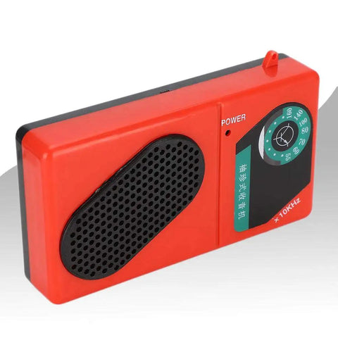 Red electronic DIY radio kit with 3V 6 tube S66E classic circuit, visible front input transformer and dial, hands on friendly