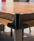 4 Pack Silicone Corner Guards for Furniture and Tables, Easy Install Edge Protectors, Black Bumpers on wooden table corner