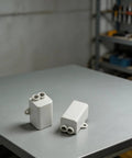 Heavy Duty T Shape Terminal Block Quick Wire Connector 1000V 100A Cable Splitter on a table, showcasing two plastic connectors.