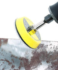 2 Inch Hook And Loop Sanding Pad With One Eighth Mandrel Adapter For Drills And Rotary Tools in use on a metal surface.