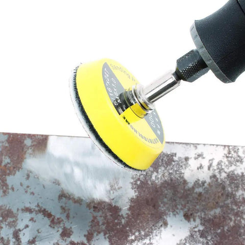 2 Inch Hook And Loop Sanding Pad With One Eighth Mandrel Adapter For Drills And Rotary Tools in use on a metal surface.