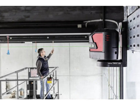 Knockout Green Beam Cross Line Laser Level projecting green lines as a user aligns fixtures on a scaffolding.