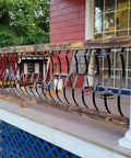 51 Pack 29.5 Inch Matte Black Iron Deck Balusters With Complete Hardware Kit For Exterior Stair Railing And Porch Safety Fences That Look Dope And Install Like A Breeze No Stress At All installed on wooden porch railing.
