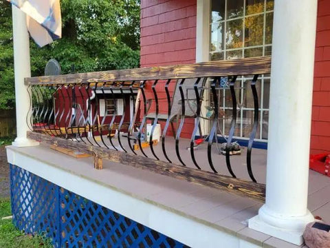 51 Pack 29.5 Inch Matte Black Iron Deck Balusters With Complete Hardware Kit For Exterior Stair Railing And Porch Safety Fences That Look Dope And Install Like A Breeze No Stress At All installed on wooden porch railing.