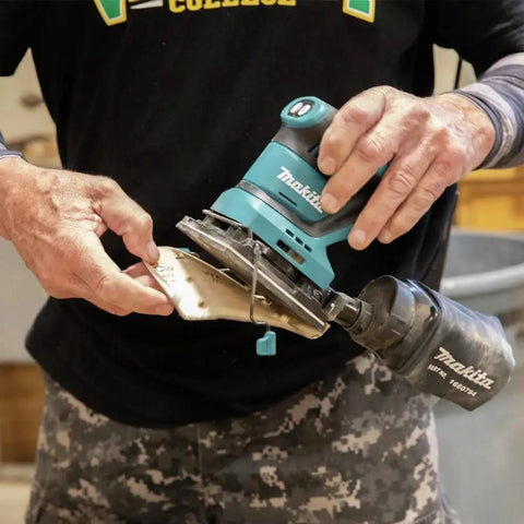 18V Cordless 1/4 Sheet Finishing Sander With Two Speed Control 11K And 14K OPM held in hand, changing abrasive paper