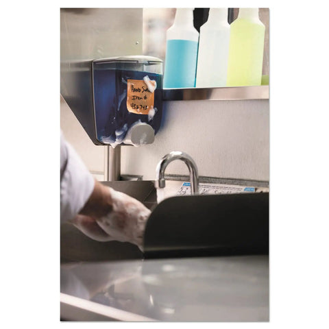 Person washing hands near dispenser labeled with Extreme Weather Sticky Notes 3x3 Inch 45 Sheets Per Pad 3 Pads in kitchen.