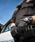 Officer wearing Heavy Duty Tactical Recon Gloves With Slim Fit Leather For Maximum Dexterity Touchscreen Compatible And Machine Washable.