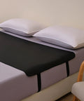 Bedside Grounding Mat For Sleep And Deep Relaxation No Electricity Needed on bed with white pillows and vegan leather surface